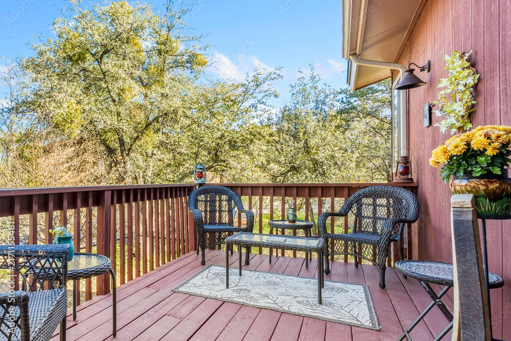 Naklejka premium Deck seating on sunny wooden balcony