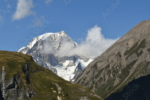Majestic snow covered peaks of Mont Blanc massif mountain peaks under blue sky with clouds, scenic alpine summit landscape view from Little St Bernard Pass, Aosta Valley, Italy