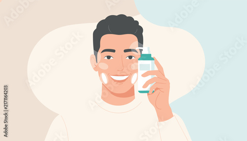 Smiling young handsome man holding a skincare lotion bottle while wearing dabs of white moisturizing cream on his face.