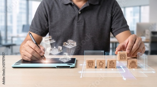 Architect planning project with digital tablet and wooden blocks with icons