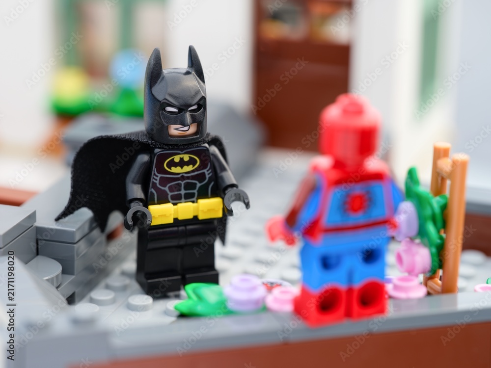 Obraz premium Tambov, Russian Federation - August 23, 2026 A Lego Batman minifigure facing Spider-Man on a brick-built rooftop terrace.