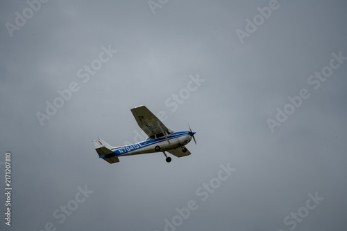 St Paul, MN - 26 Aug 25: Small Propeller Airplane Flying in Gray Sky