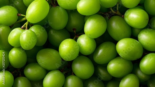 Fresh green grapes shine in soft, vibrant light