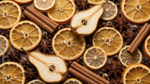 Dried Orange Slices, Pear Halves, Cinnamon Sticks, and Star Anise Spices Background, concept of natural ingredients and seasonal flavors