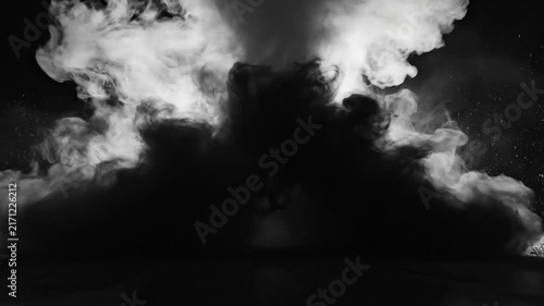Black and white slow motion explosion effect with swirling smoke, dramatic visual impact, and dark atmosphere