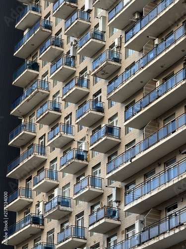 Картината върху платно Urban high-rise building facade with numerous balconies, showcasing modern city architecture