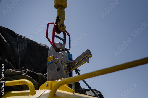 The Fast Rescue Craft connected to the  FRC davit through the quick release hook. The lifting device is used to securely grip and handle FRC lowering
