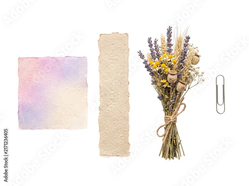 Flat lay composition with a watercolor note, handmade paper, dried flower bouquet, and paper clip isolated on transparent background