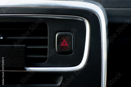 Close-up of a Volvo dashboard hazard warning button with a red triangle symbol
