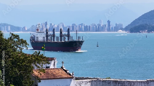Grande Navio chegando no Canal do Porto de Santos com Bandeira do Brasil e Orla da Cidade ao Fundo