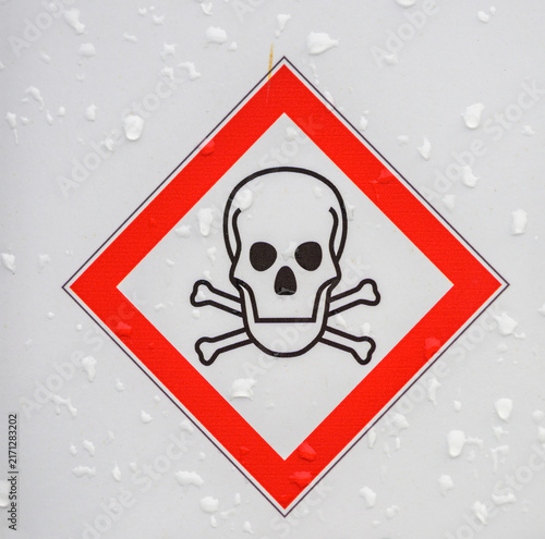 Картината върху платно Toxic hazard skull and crossbones warning symbol in rain.
