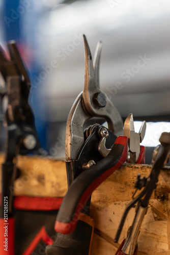 Quadro su tela Repair tools rest in wooden holder with pliers and cutters pressed together in tight close up