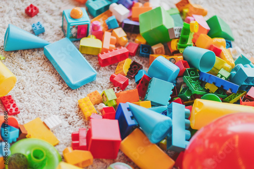 Colorful chaos of toys scattered across a soft carpeted floor during a sunny afternoon of playtime adventures