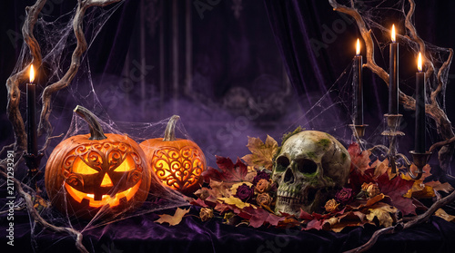 Halloween Jack O Lanterns Burning in a Dark Forest at Night with Fiery Flames, Glowing Pumpkins, Campfire, Warm Orange Light and Spooky Autumn Atmosphere
