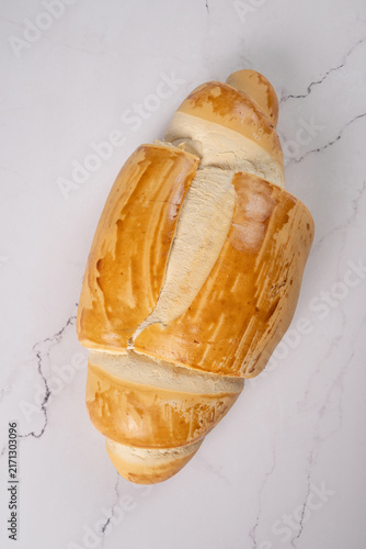 Breads,  beautiful, delicious loaves seen from above on a light, marbled surface, selective focus, top view.