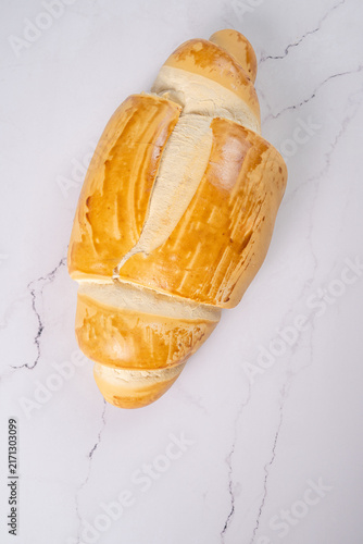Breads,  beautiful, delicious loaves seen from above on a light, marbled surface, selective focus, top view.
