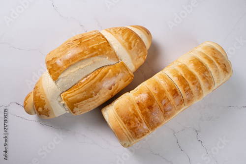 Breads,  beautiful, delicious loaves seen from above on a light, marbled surface, selective focus, top view.