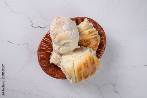 Breads,  beautiful, delicious loaves seen from above on a light, marbled surface, selective focus, top view.