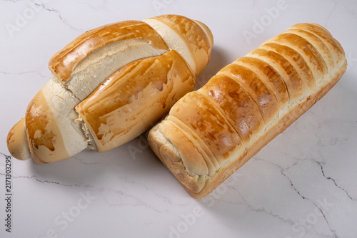 Breads,  beautiful, delicious loaves seen from above on a light, marbled surface, selective focus, top view.
