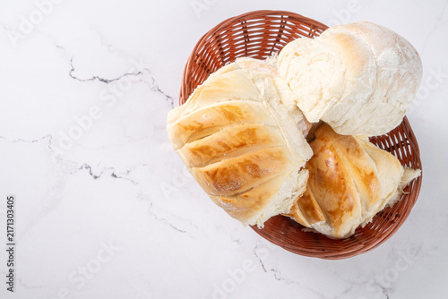 Breads,  beautiful, delicious loaves seen from above on a light, marbled surface, selective focus, top view.