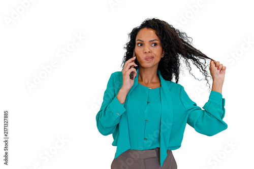 Bild auf Leinwand Woman talking on smartphone, showing indecision while pulling her curly hair