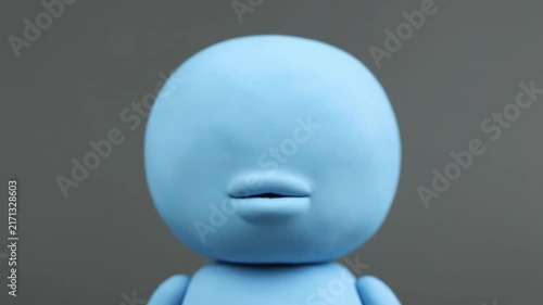 Close up of a blue clay character with a beak and lips.