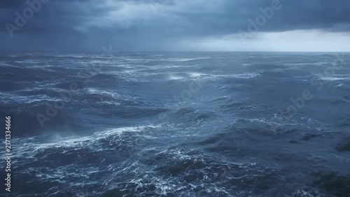 Rough ocean waves breaking under dark storm clouds across open water