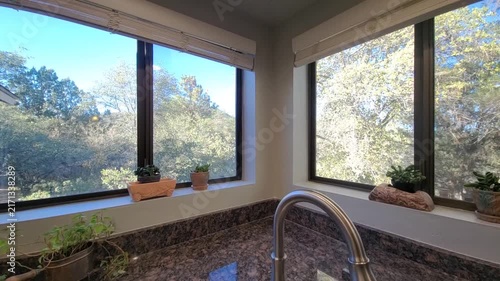 Bright kitchen with granite countertop and large windows