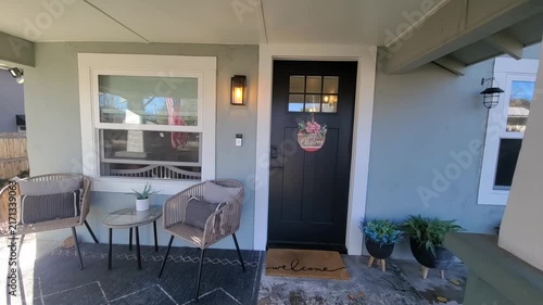 Cozy suburban porch seating at a sunny front entry