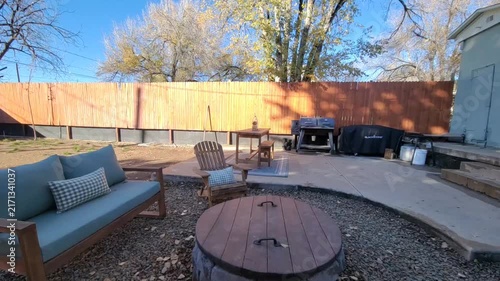 Sunny backyard patio with blue outdoor sofa