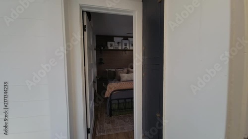 Cozy hallway leads to bright living area with ladder and blanket