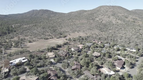 Aerial view of sunlit hillside desert village