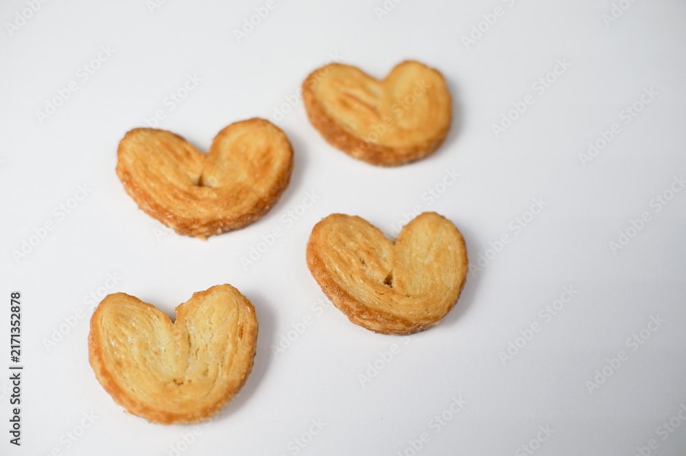 Fototapeta premium Delicious Heart Shaped Palmiers Cookies on White Background.