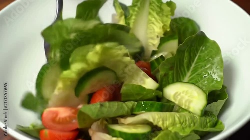 Close Up Of Fresh Salad Being Tossed In A Bowl Showcasing Crisp Greens, Juicy Tomatoes, And Sliced Cucumber For Healthy Eating Concepts