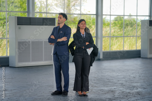 Quadro su tela Businesswoman businessman suit office warehouse leadership confidence teamwork,
