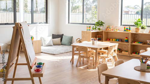 Bright and modern children's playroom with wooden furniture and toys.