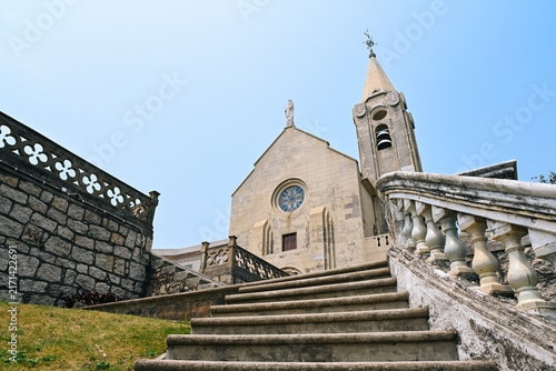 Low angle view of ancient Portuguese Our Lady of Penha Chapel with stone stairs during sunny summer day in Macau landmarks travel destination