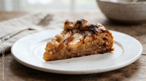 Macro Shot Spiced Pear Frangipane Galette Slice Standing Alone White Plate Caramelized Edges Catching Light

