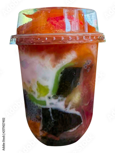 Layered tropical dessert drink with black jelly, green jelly, creamy ice, fruit