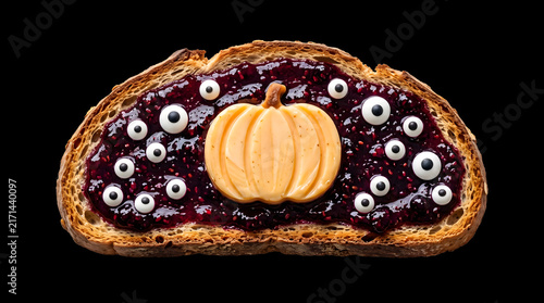 Chocolate Nut Cake with Cream and Sweet Bakery Roll on a Black Background