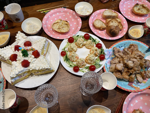 Fotografie Homemade celebration table with cake and assorted party food