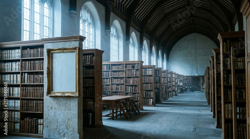 Empty old library interior with tall wooden bookshelves