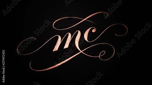 Obraz na płótnie Rose gold script mc calligraphy logo on black.