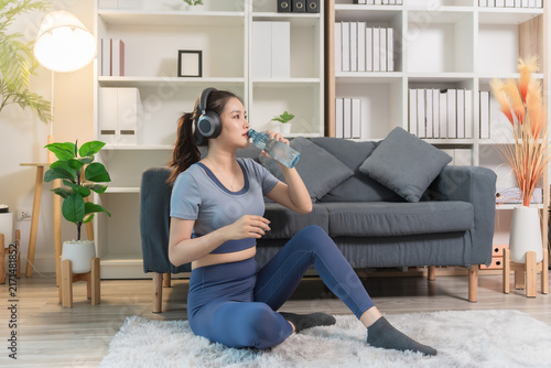 A sporty woman in sportswear exercises at home	