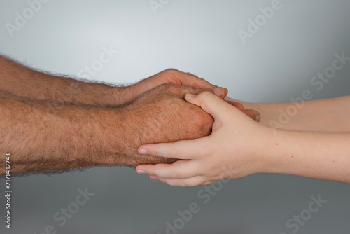 Obraz na plátně Parent hand protects child arm