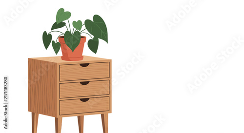 Wooden bedroom nightstand with three drawers and a vibrant green potted plant sitting on its smooth top surface.