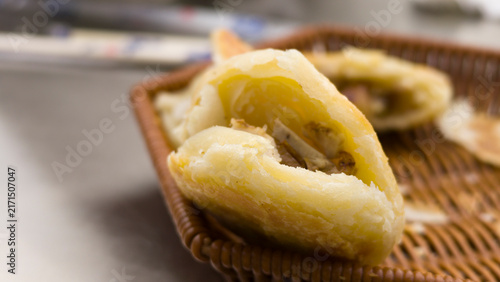 Принти на полотні Chinese kid eating local specialty Duijia, a traditional Chinese snack from Jingpeng Town, Hexigten Banner, Inner Mongolia