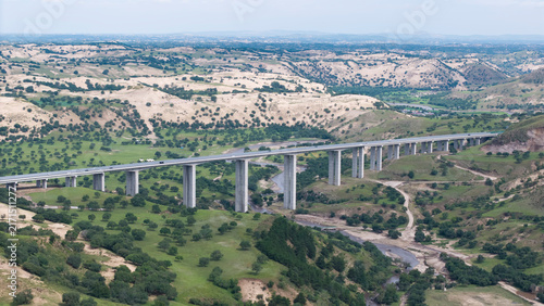 Aerial shot of Saling River Grand Bridge spanning across the river. Grand bridge construction integrated with natural landscape, transportation infrastructure in Inner Mongolia grassland area.