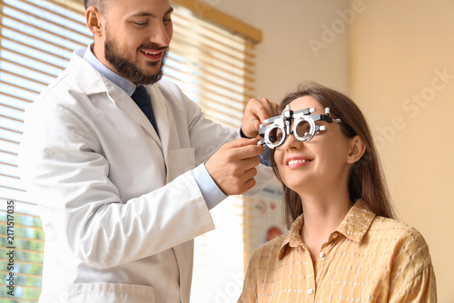 Photography Vision care and eye health, optometrist examining a young womans eyesight with a