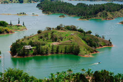 Guatape reservoir landscape with green islands and boat